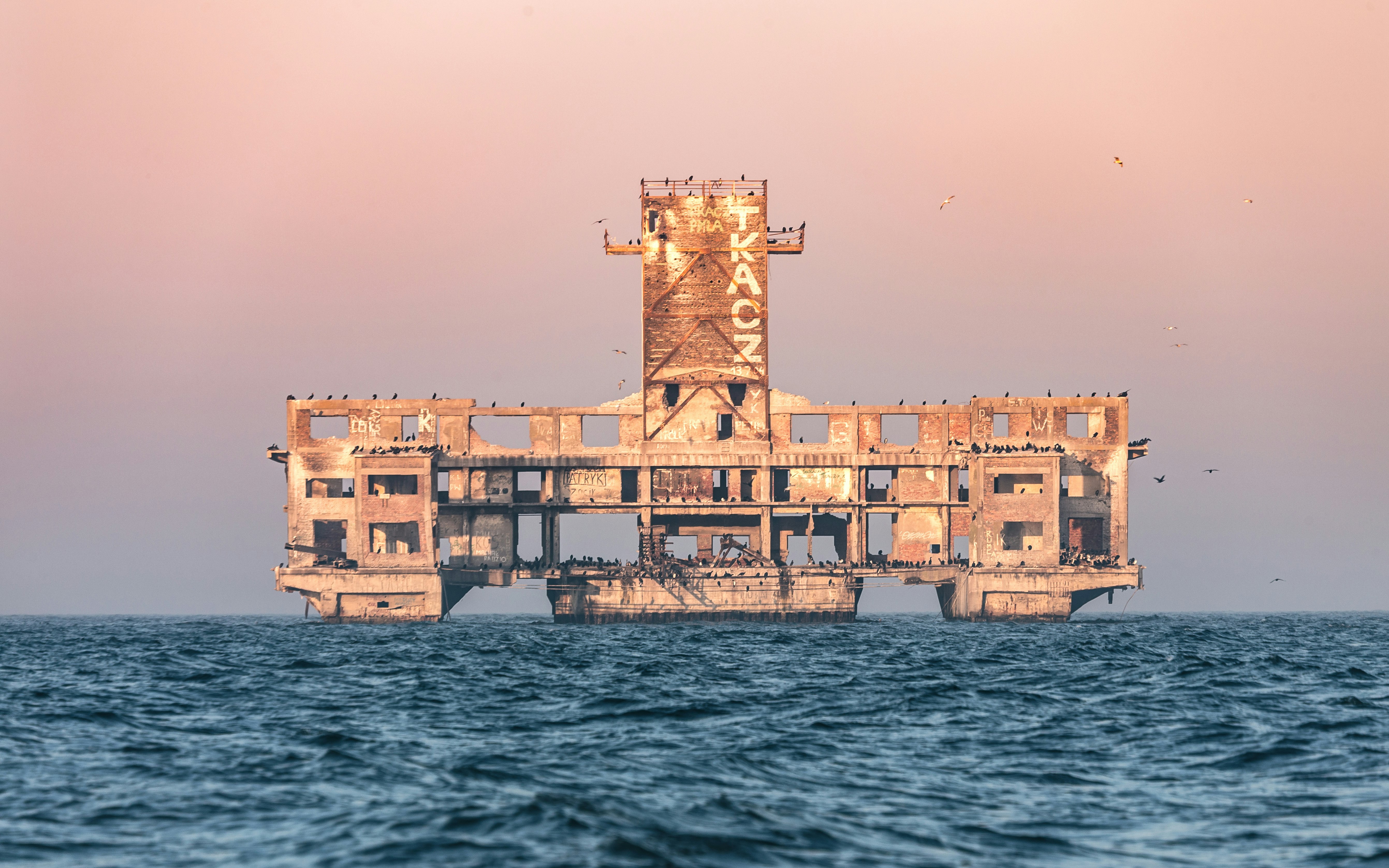 brown concrete building on body of water during daytime